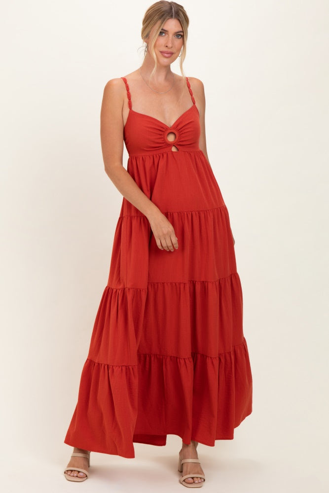 woman wearing a rust tiered maxi dress with a front cut-out and spaghetti straps