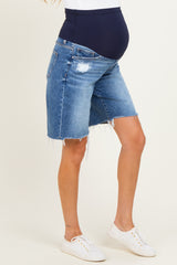 woman wearing blue maternity denim shorts with a navy belly panel and frayed hem