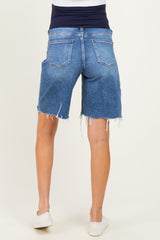 woman wearing blue maternity denim shorts with a stretchy waistband and frayed hem