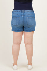 woman wearing a pair of blue maternity plus denim shorts, showing the back view with a supportive waistband