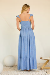 woman wearing a back view of a light blue tiered maxi dress with ruffled shoulder straps