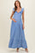 woman wearing a blue striped maxi maternity dress with ruffled sleeves and a baby bump