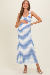 woman wearing a striped maternity maxi dress with blue and white stripes, holding her baby bump