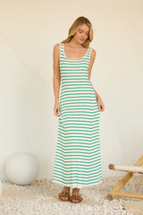 woman wearing a green and white striped maxi dress with a scoop neckline and thin straps