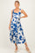 woman wearing a blue and white floral maternity dress with a tie waist and a flowing skirt, showcasing her baby bump