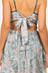 woman wearing a light blue floral crop top with tied-back detail and matching skirt, showing a back view