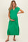 woman wearing a green maternity dress with a v-neck and side slits, holding her baby bump