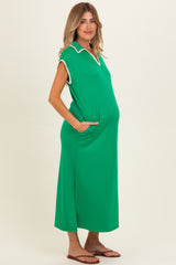woman wearing a bright green maternity dress with a collar and pockets, showcasing her baby bump