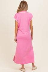 woman wearing a pink maternity maxi dress with short sleeves and side slits, viewed from the back
