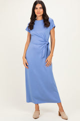 woman wearing a light blue maxi dress with short sleeves and a side tie detail
