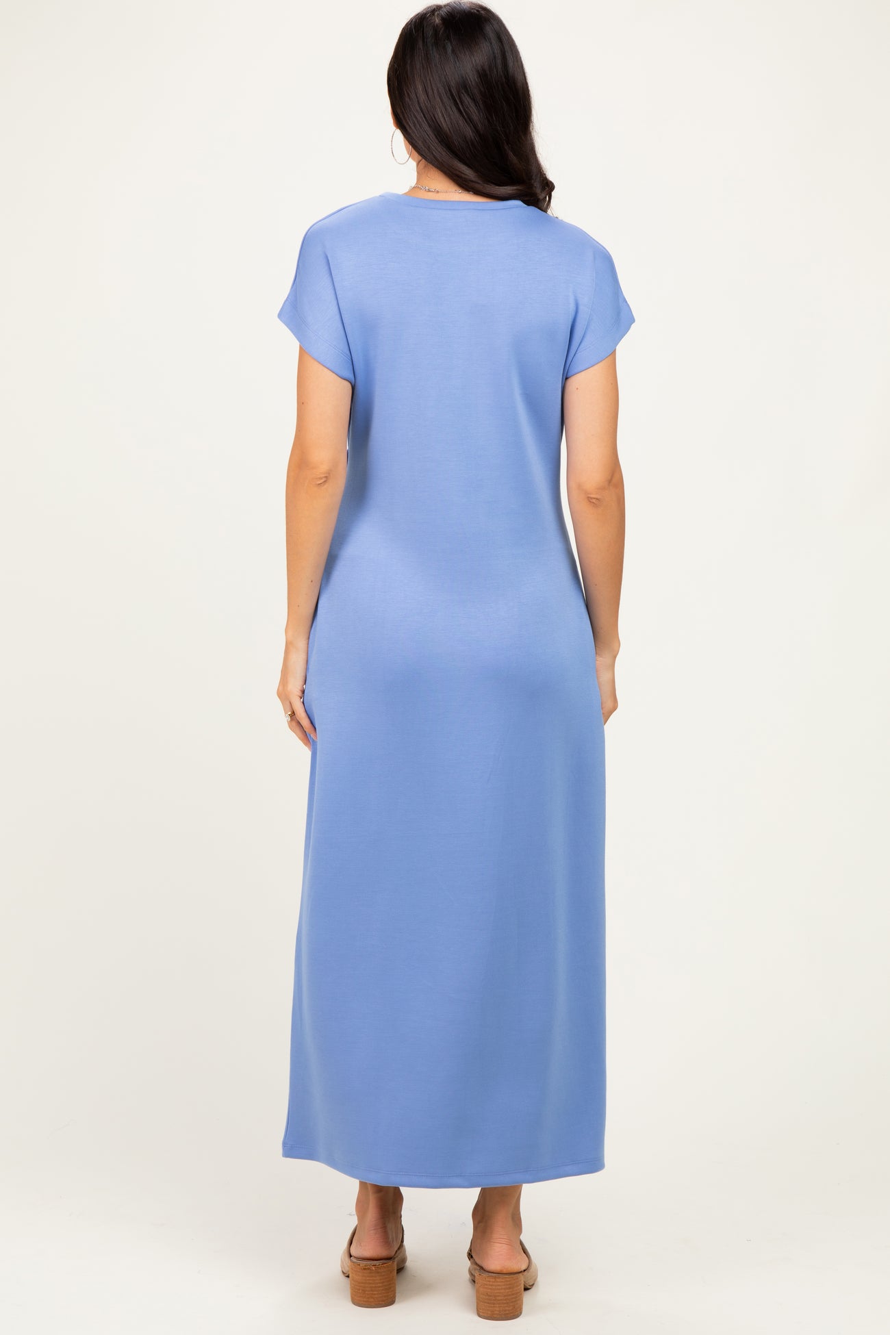 woman wearing a light blue short sleeve maxi dress with a relaxed fit, shown from the back