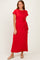 woman wearing a red short sleeve maxi dress with a knotted waist detail and beige flats