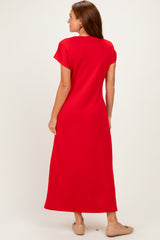 woman wearing a bright red short sleeve maxi dress, viewed from the back