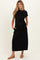 woman wearing a black maternity maxi dress with a side tie and pockets, highlighting her baby bump