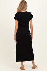 woman wearing a black short sleeve maternity maxi dress, view from the back