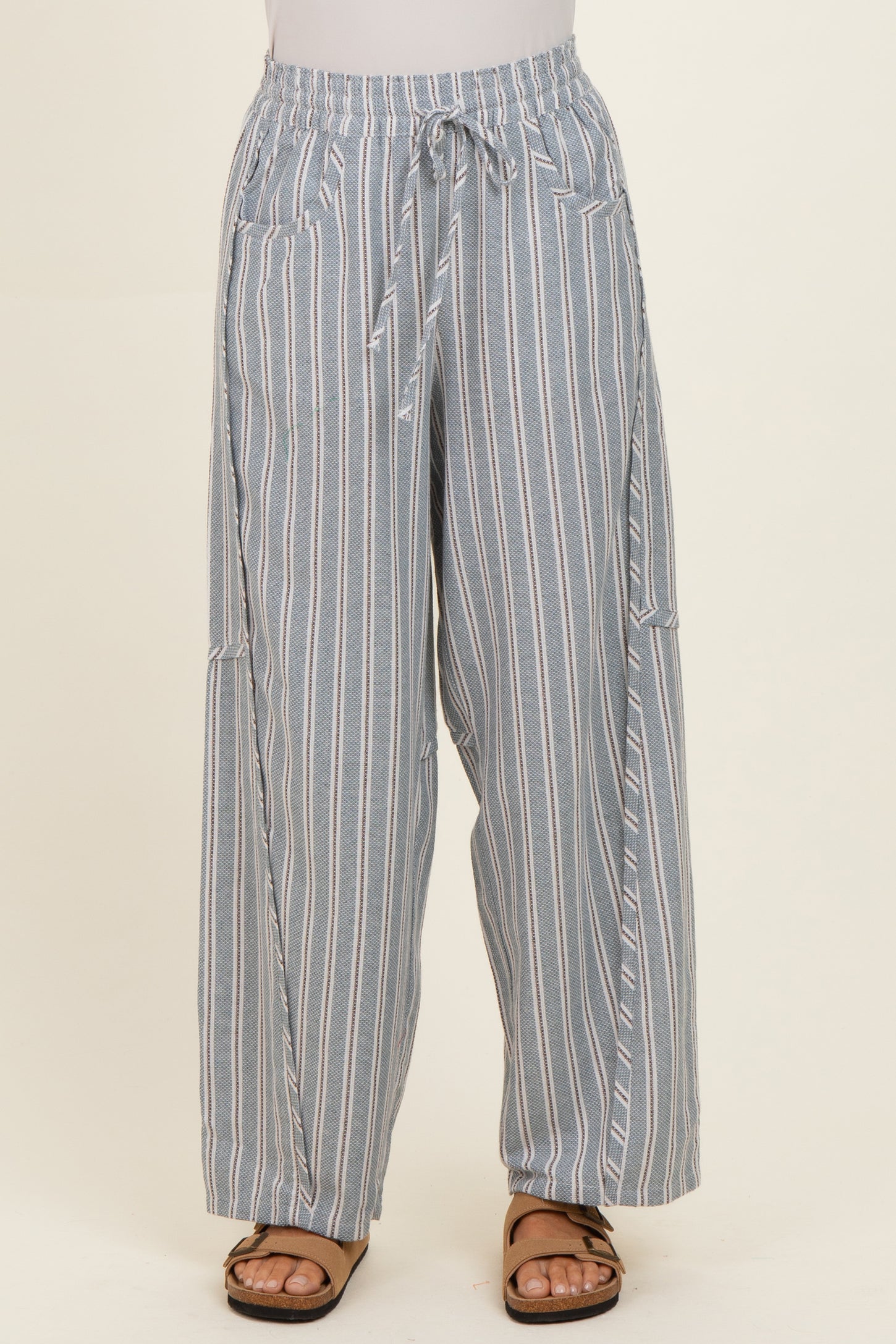 woman wearing blue and white striped wide-leg pants with an elastic waistband and side pockets