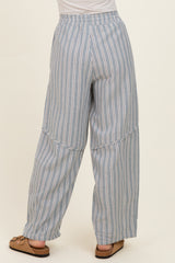 woman wearing light blue striped wide-leg pants with an elastic waistband, viewed from the back