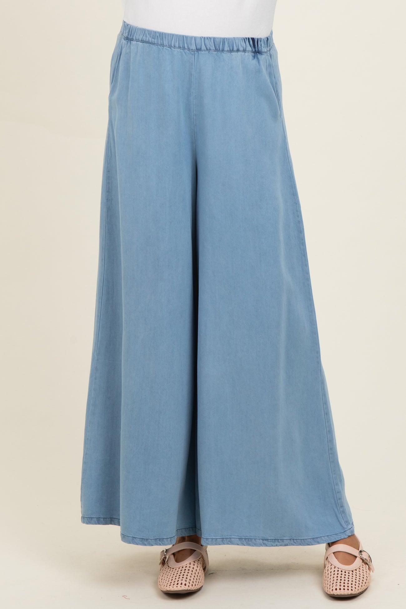 woman wearing light blue wide-leg maternity pants with an elastic waistband and a relaxed fit
