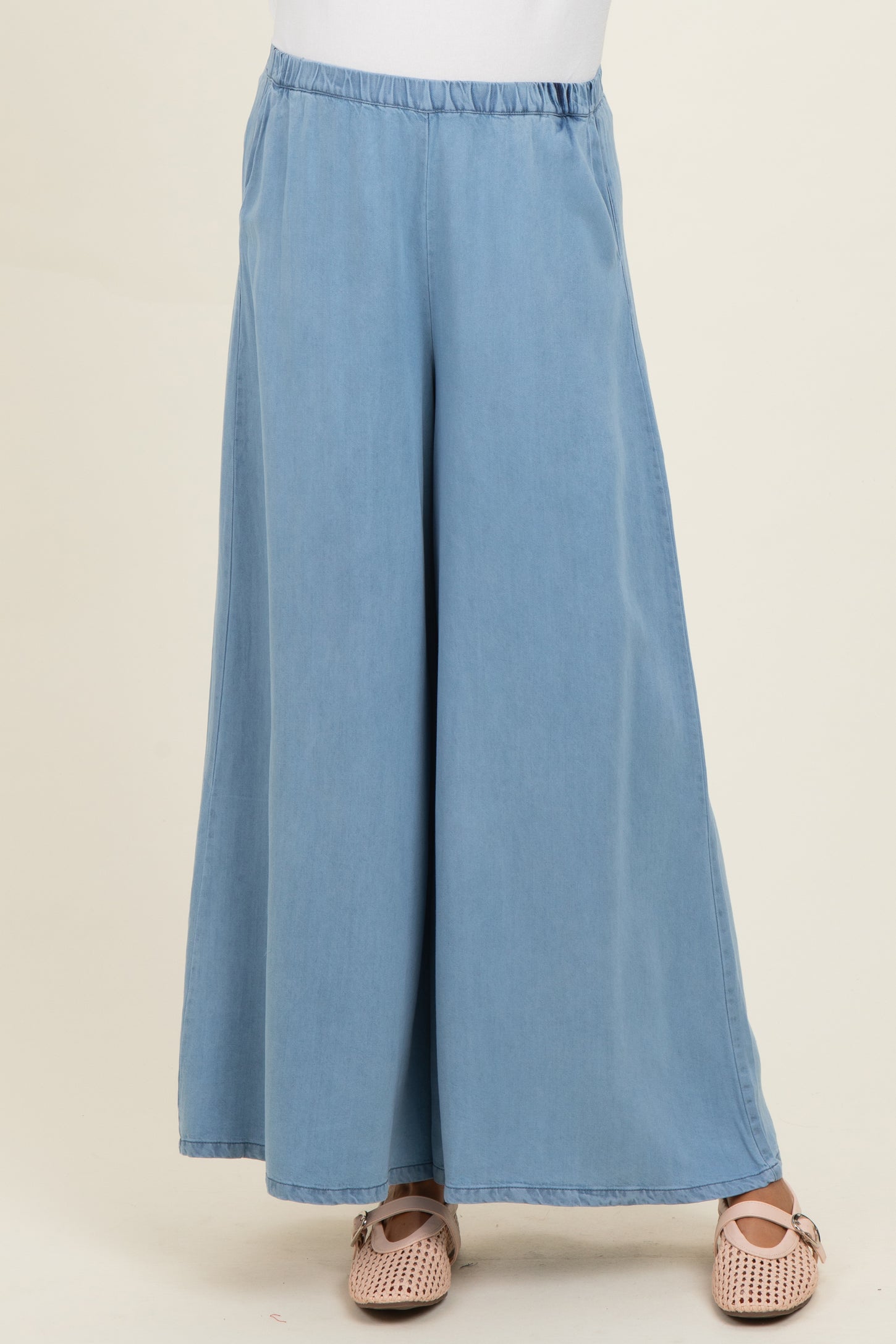 woman wearing light blue wide-leg maternity pants with an elastic waistband and a relaxed fit