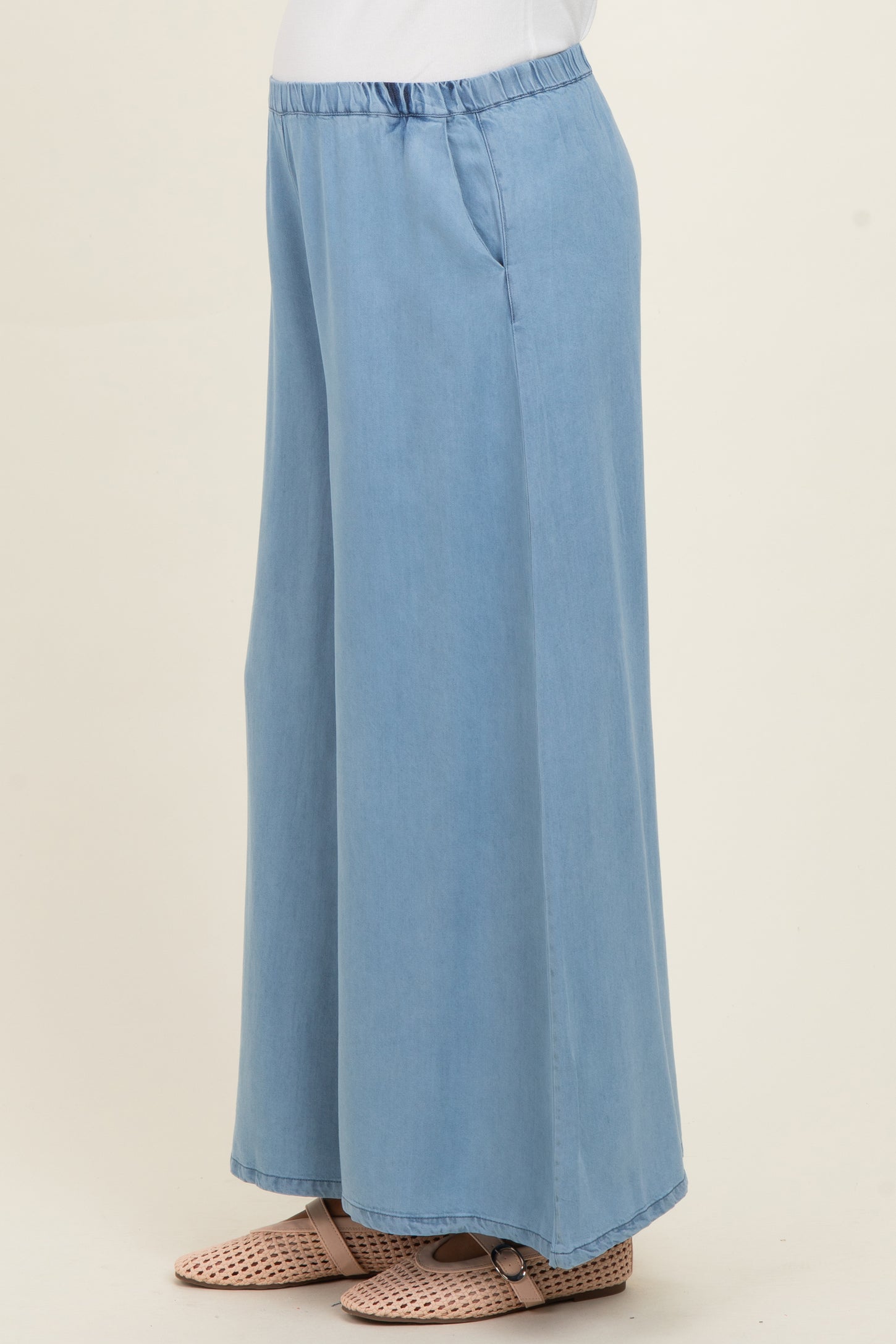 woman wearing light blue wide-leg maternity pants with pockets and an elastic waistband