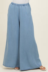 woman wearing light blue wide-leg pants with an elastic waistband, styled for a casual look