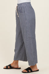 woman wearing blue and white striped wide-leg pants with a drawstring and pockets