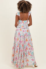 woman wearing a floral maxi maternity dress with ruffle straps, showing the back and flowy silhouette
