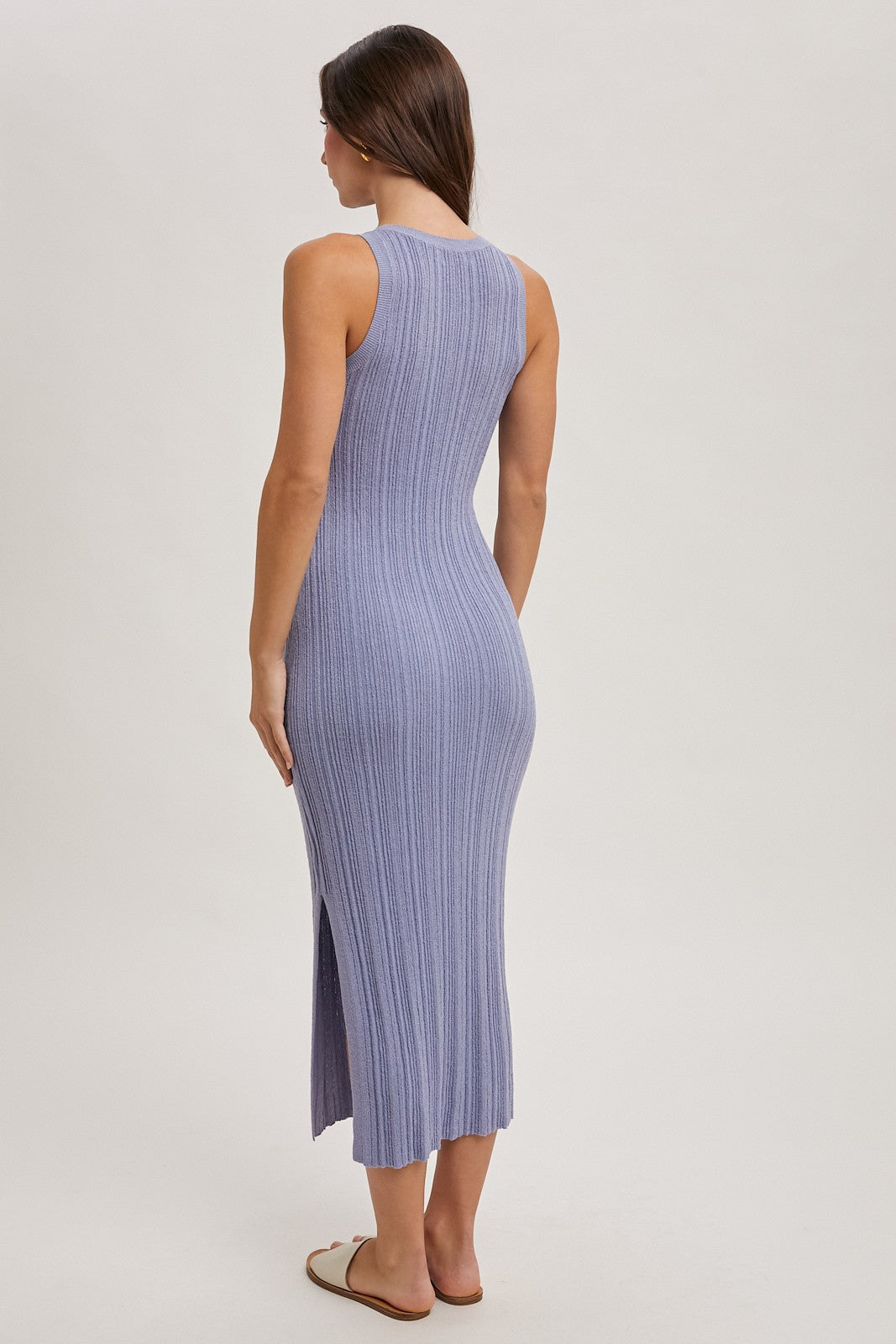 woman wearing a lavender ribbed maxi dress with a side slit, viewed from the back