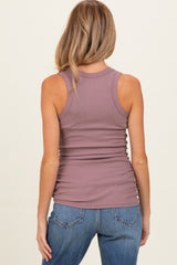 woman wearing a mauve ribbed maternity tank top, viewed from the back, styled with blue jeans
