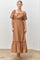 woman wearing a brown puff sleeve maxi dress with a square neckline and ruffled hem