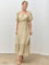woman wearing a beige tiered maxi dress with puff sleeves and a square neckline