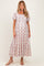 woman wearing a floral maternity maxi dress with short sleeves and a square neckline, showcasing her baby bump