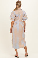 woman wearing a beige and blue striped maternity dress with short puff sleeves, showing a relaxed fit from the back
