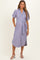 woman wearing a blue and pink striped short sleeve maternity shirt dress with a tied waist and pockets