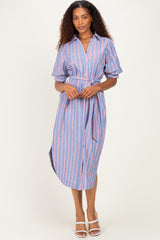 woman wearing a striped blue and pink midi shirt dress with short sleeves and a tie belt