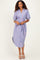 woman wearing a striped blue and pink midi shirt dress with short sleeves and a tie belt