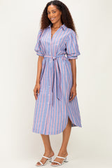 woman wearing a blue and pink striped button-up dress with a tie waist and short puff sleeves