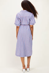 woman wearing a blue and pink striped midi dress with short sleeves and a belted waist, shown from the back