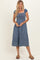 woman wearing a blue smocked midi dress with short puff sleeves and a relaxed fit
