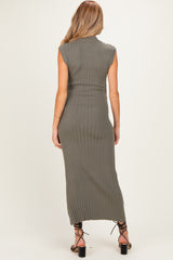 woman wearing a fitted olive green ribbed maxi dress with short sleeves, showing a side view of the back and slits