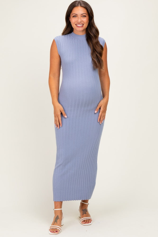 woman wearing a form-fitting light blue ribbed maternity maxi dress, showing off her baby bump