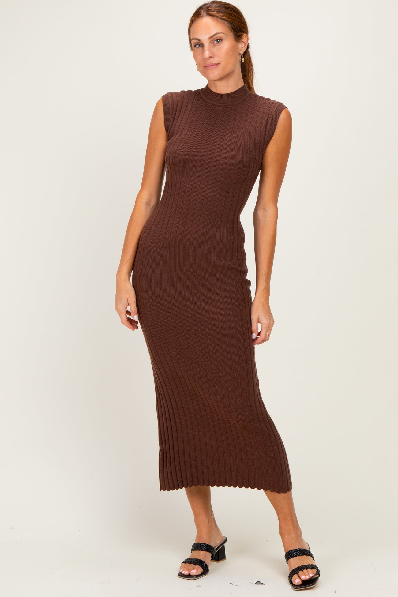 woman wearing a brown ribbed sleeveless midi dress and black heeled sandals