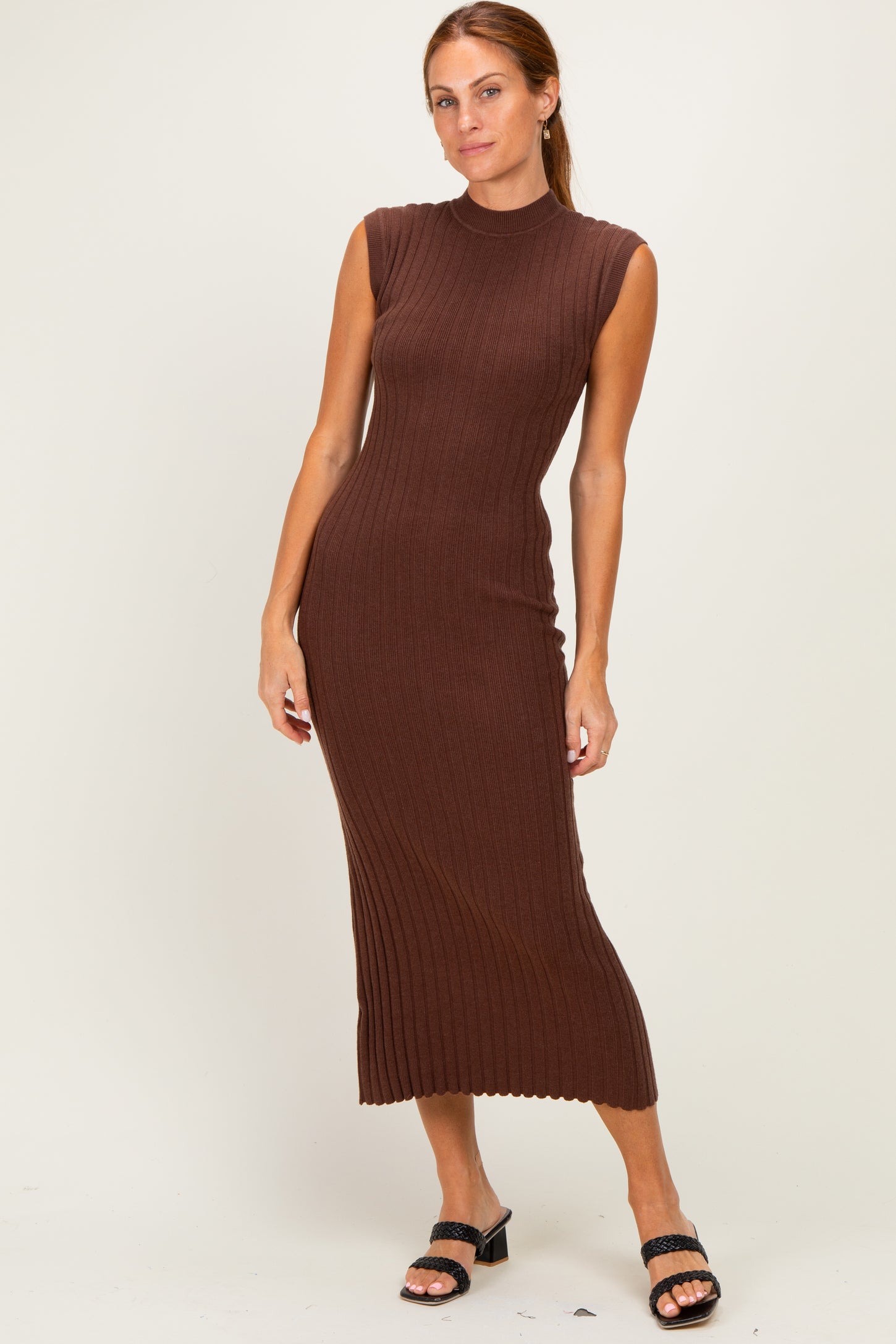 woman wearing a brown ribbed sleeveless midi dress and black heeled sandals