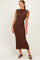 woman wearing a brown ribbed sleeveless midi dress and black heeled sandals