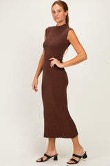 woman wearing a chocolate brown sleeveless ribbed knit midi dress with a high neckline and scalloped hem