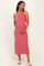 woman wearing a rosy pink ribbed maternity dress and holding her baby bump