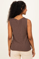 woman wearing a brown sleeveless maternity top, viewed from the back