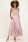 woman wearing a pink maternity maxi dress with ruffle straps and tiered design, showcasing her baby bump
