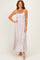 woman wearing a light pink maxi dress with lace detailing and spaghetti straps