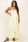 woman wearing a yellow maternity maxi dress with eyelet detail and a visible baby bump
